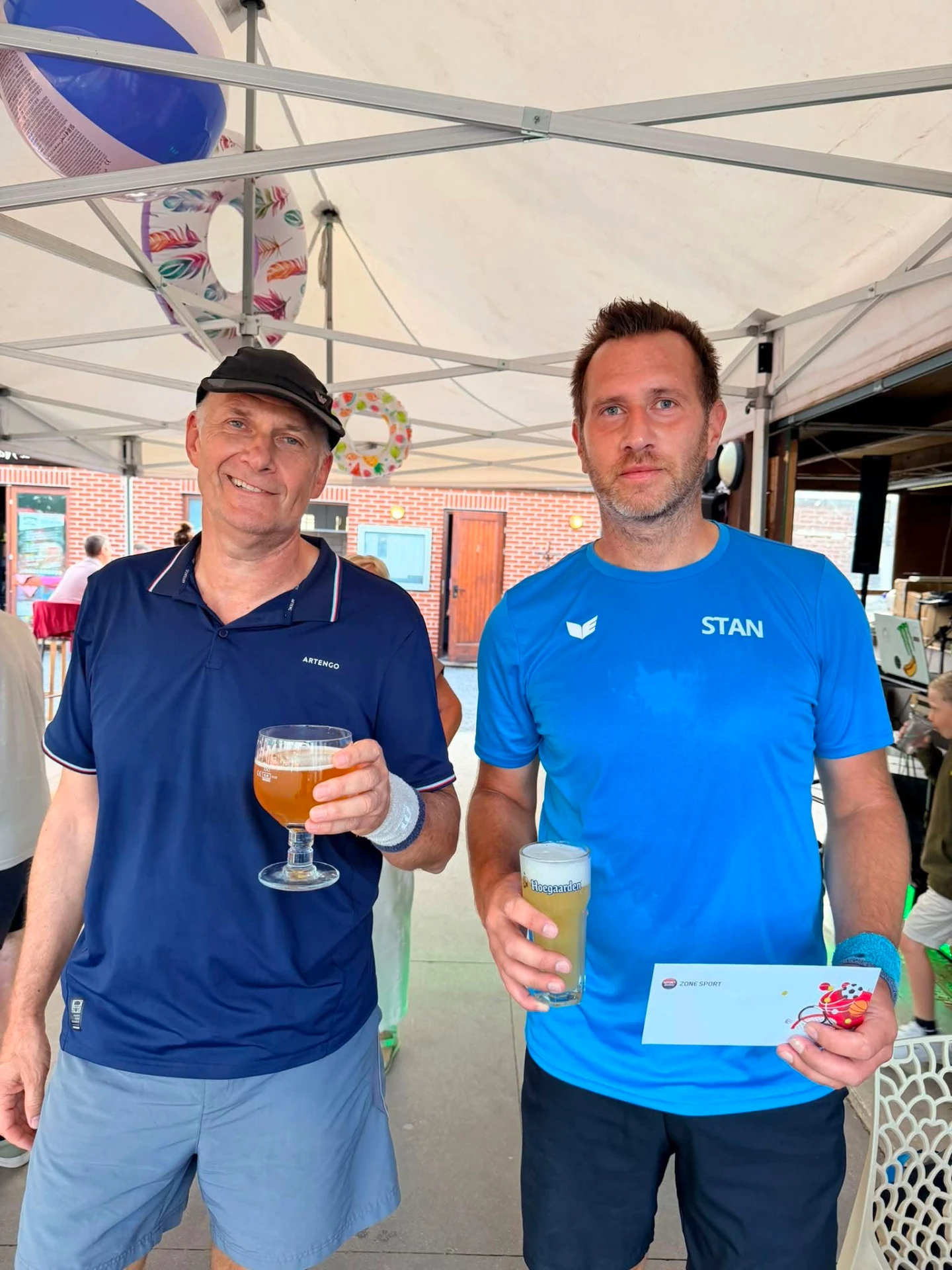 Vainqueur et finaliste messieurs trinquant sous la tente du club